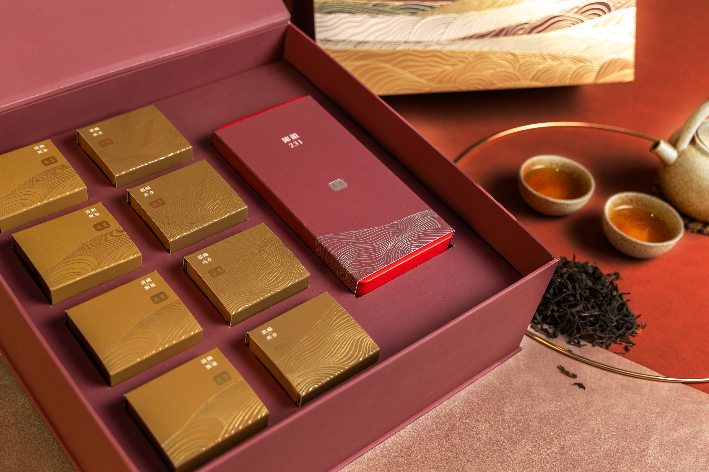Yik Fung Tea packaging arranged with tea cups and loose tea
